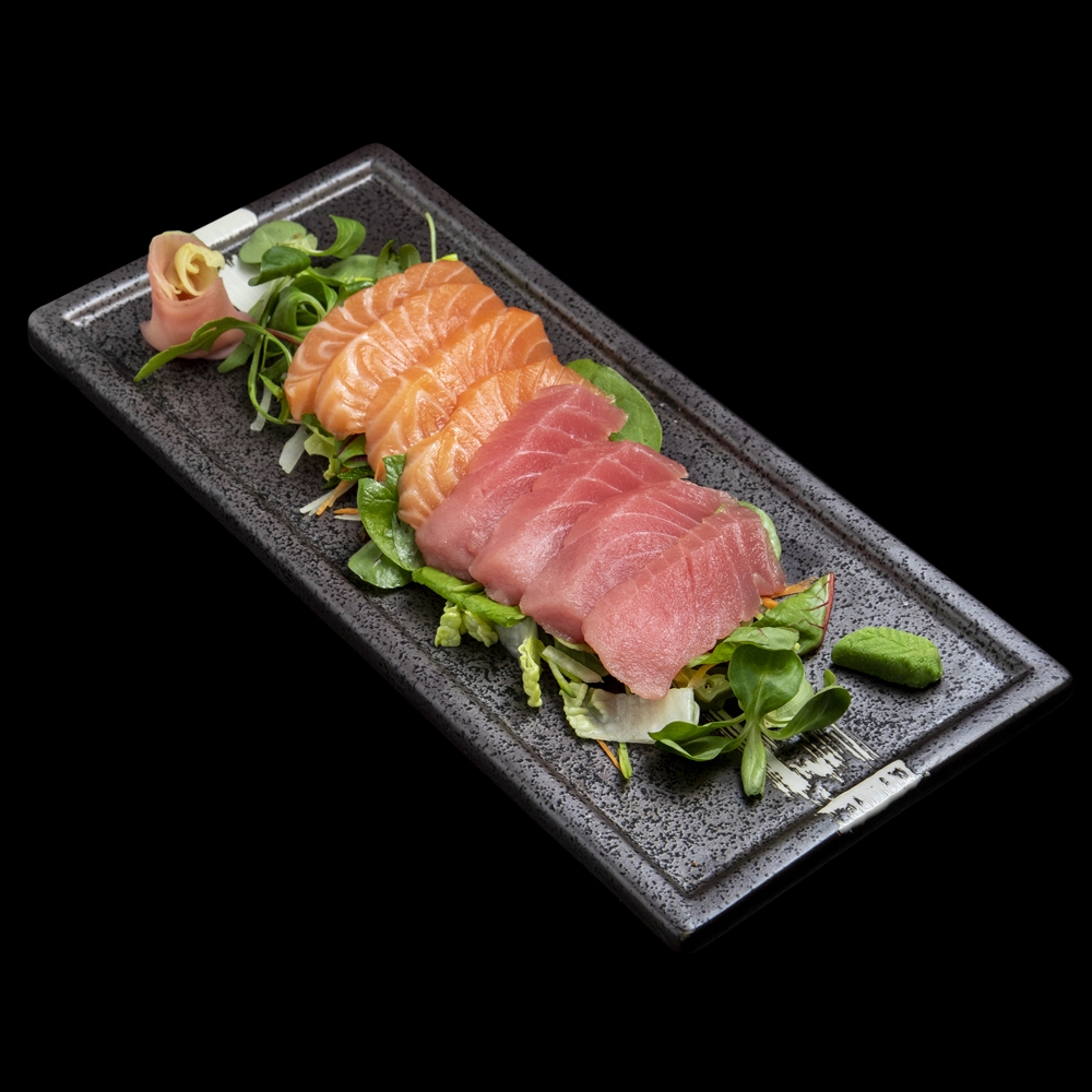 Salmon and tuna sashimi on green salad