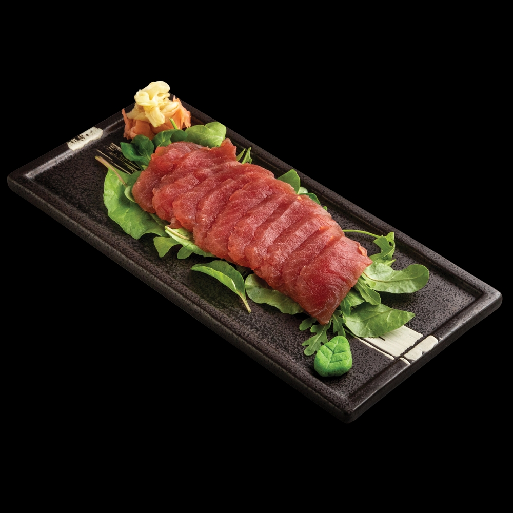 Tuna sashimi on a bed of green salad